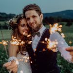 beautiful-bride-and-groom-on-a-meadow-in-the-eveni-P8TUGS9-gallery.jpg